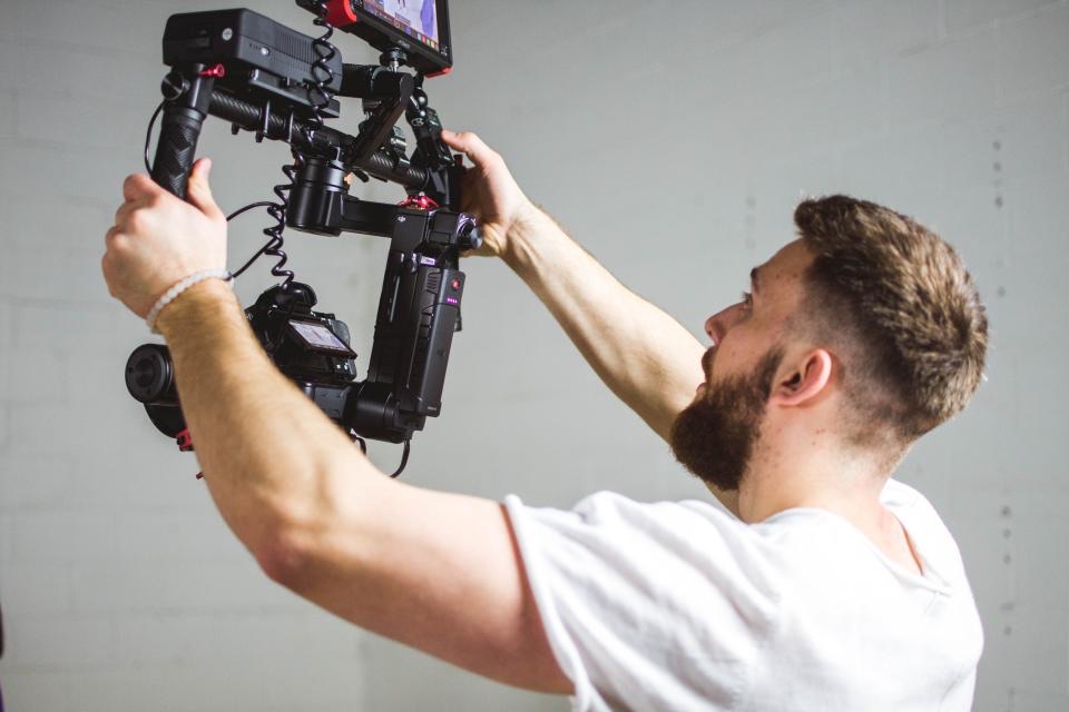 Camera operator rigging a cinema camera on a gimbal